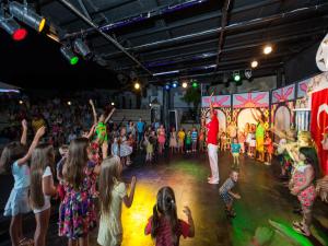 a group of children dancing in a crowd at a circus at Lykia Botanika Beach Fun & Club - All Inclusive in Fethiye