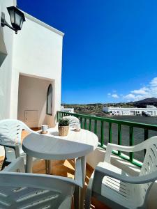 a patio with a table and chairs on a balcony at Maresía Apartamento in El Golfo