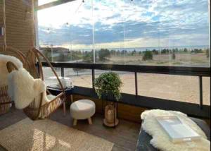 a room with a large window with a view of the beach at SunBeach Apartment with seaview and sauna in Kalajoki