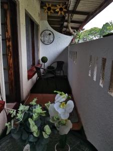 a balcony with a table with white flowers on it at 23 Villa Mia St Lucia in St Lucia