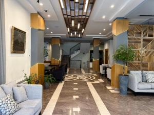 a lobby with couches and stairs in a building at Yerevan Resident Hotel in Yerevan