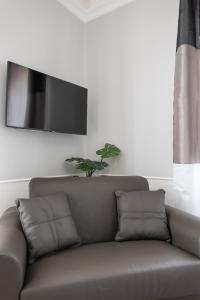 a couch sitting in a living room with a tv at Golfo dei Poeti Retreat in La Spezia