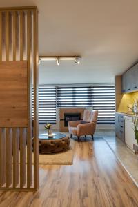 a living room with a chair and a coffee table at IN LUX APARTMAN in Vrnjačka Banja