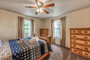 a bedroom with a bed and a ceiling fan at Four Cubs in Ruidoso