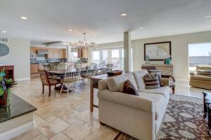 a living room with a couch and a dining room at The Bridge At South Oceanside is the Perfect Family Beach House now with AC in Oceanside