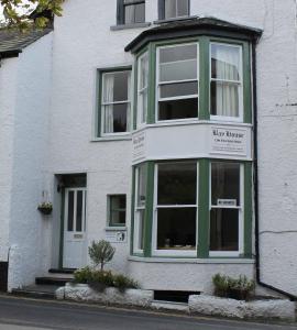 een wit gebouw met een groen en wit raam bij The Bay House Lake View Guest House - Adults Only in Bowness-on-Windermere