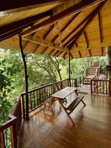 una terraza de madera con una mesa de picnic y escaleras en Cinnamon View Lodge Mirissa, en Mirissa