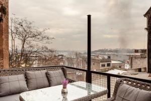 a balcony with a table and a view of a city at Origine Rentals Galata Tower in Istanbul