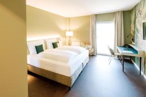 Voodi või voodid majutusasutuse Hotel am Zoo toas