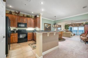 a kitchen with wooden cabinets and a counter top at 852 Cinnamon Beach in Palm Coast