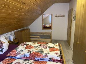 a bedroom with a bed with a floral comforter at Ferienwohnung Familie Putschke in Nohra