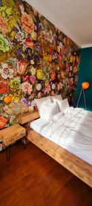 a bedroom with a flower wall with a bed at Paradiso Perduto Private Apartment by Weinkeller in Sibiu