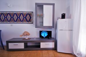 a room with a table and a white refrigerator at Sa di Mare in Bibione