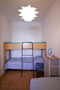 a bedroom with two bunk beds and a chandelier at Sa di Mare in Bibione +35 photos