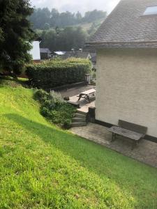 a picnic table and a bench next to a building at Hausamaarbach in Willingen