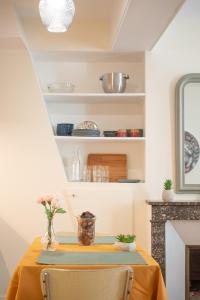 a dining room with a table with a yellow table cloth at Charmant 2 pièces in Poissy