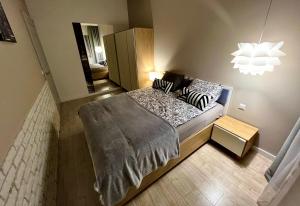 a bedroom with a bed with pillows on it at Apartament Byka in Poznań