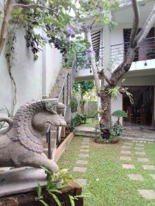 a stone dragon statue sitting in front of a building at Kelaniya Heritage in Kelaniya +43 photos