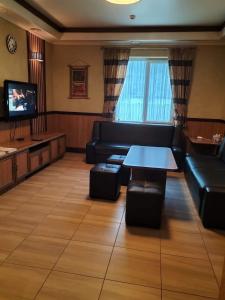 A television and/or entertainment centre at Tartak Resort