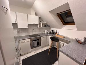 a kitchen with white cabinets and a counter top at Gemütliches Appartement an der Riß in Biberach an der Riß