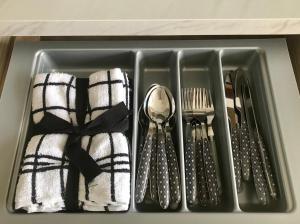 a tray filled with utensils and spoons and forks at Caledonian lodges 3 Inverness in Inverness