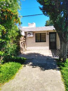 una casa de ladrillo con un árbol delante de ella en Apartamento Monoambiente Independiente en Salto Ciudad, en Salto