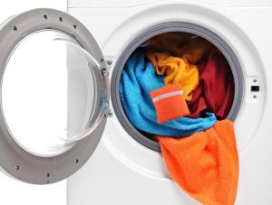a washing machine filled with towels in a washing machine at Green Holiday Village with Pool in Bibione