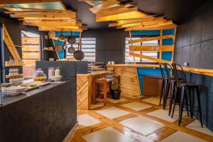 a kitchen with wooden floors and a counter with stools at The Grand La Paz Experience Hotel Boutique in La Paz