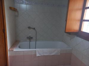 a bathroom with a bath tub with a shower at Il Nido dell'aquila in Sardara +40 photos