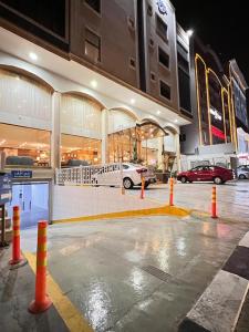 a parking lot with orange cones in front of a building at Al Jury Serviced Apartments in Al Khobar