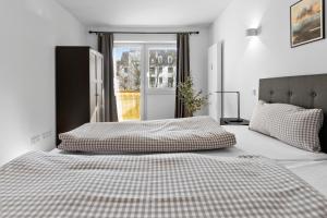 Giường trong phòng chung tại Flatista Homes - Hirschgarten