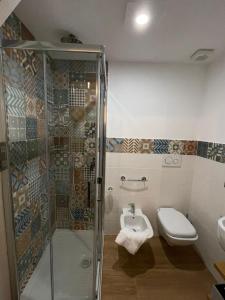 a bathroom with a shower and a toilet and a sink at Casa Vacanze al Trenta3 in Marsala