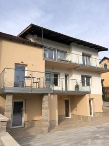 an apartment building with a balcony and patio at Maximo Apartments - free parking in Maribor