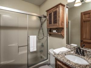 a bathroom with a shower and a toilet and a sink at Midtown Riverfront 3 in Ruidoso +13 photos