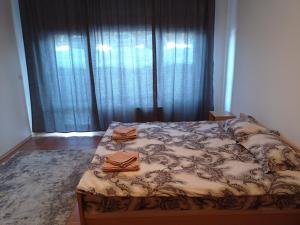 a bedroom with a bed with two robes on it at Free SPA Pirin lodge cosy apartment in Bansko