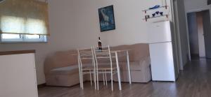 a living room with a couch and a table and chairs at Apartments Barbic in Medulin