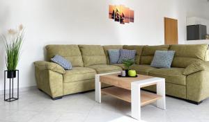 a living room with a couch and a coffee table at Apartment Kantun in Skradin