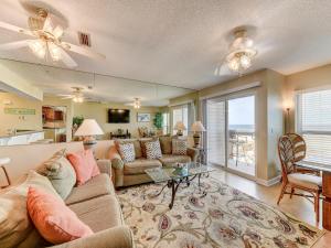 a living room with a couch and a table at Surfside Six E, 2 Bedrooms, Ocean Front, Sleeps 6, Wireless Internet in Saint Augustine