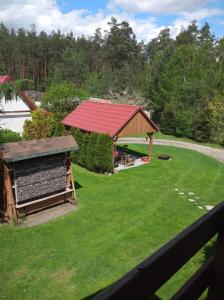 a gazebo with a red roof in a yard at Agroturystyka u Wioli i Irka , apartament u Beaty in Karsin +3 photos