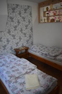 a room with two twin beds and a wall at Agroturystyka u Wioli i Irka , apartament u Beaty in Karsin