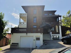 a large house with a garage in front of it at Heidi in Leysin