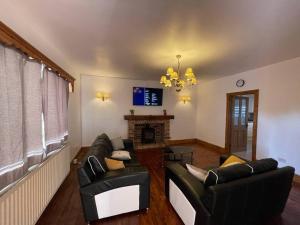 a living room with two couches and a fireplace at Park Terrace Professional Let in Bedlington