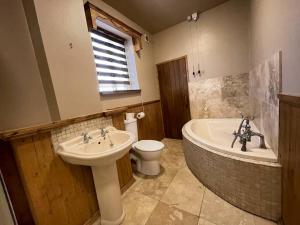 a bathroom with a sink and a tub and a toilet at Park Terrace Professional Let in Bedlington