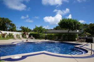 a swimming pool in a resort with a blue at Emmalani Court 312 condo in Princeville