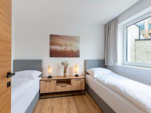 Łóżko lub łóżka w pokoju w obiekcie Apartment Alpenherz
