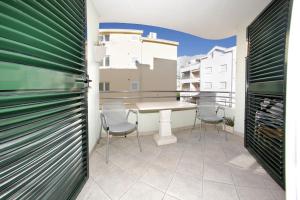 a room with a table and chairs on a balcony at Apartments Sumic in Makarska