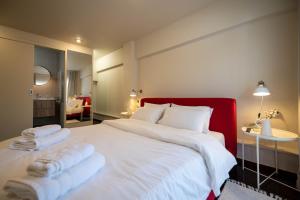 a bedroom with a large white bed with towels on it at Scala_Apartment in Kalamata