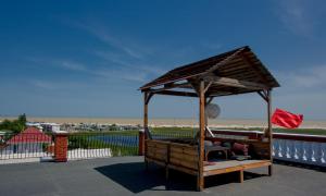 a wooden gazebo with a roof on top of a building at Mini-hotel Tikhaya Gavan in Kyrylivka