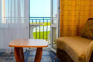 a room with a table and a chair and a window at Mini-hotel Tikhaya Gavan in Kyrylivka