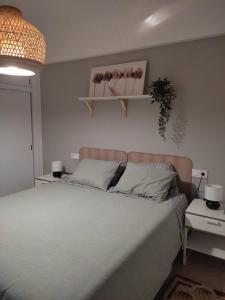 a bedroom with a bed and two shelves on the wall at Eternalbeach in Santa Pola